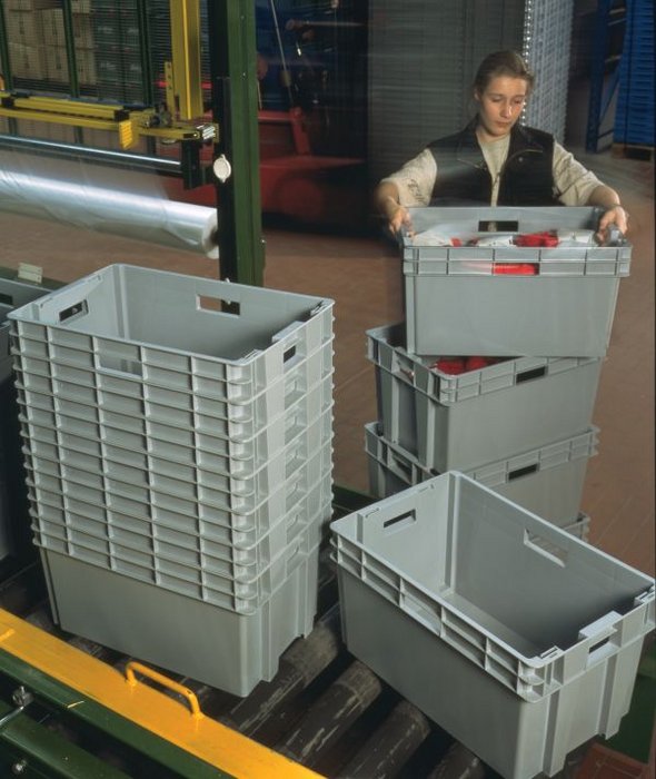Nestable container in use in a warehouse